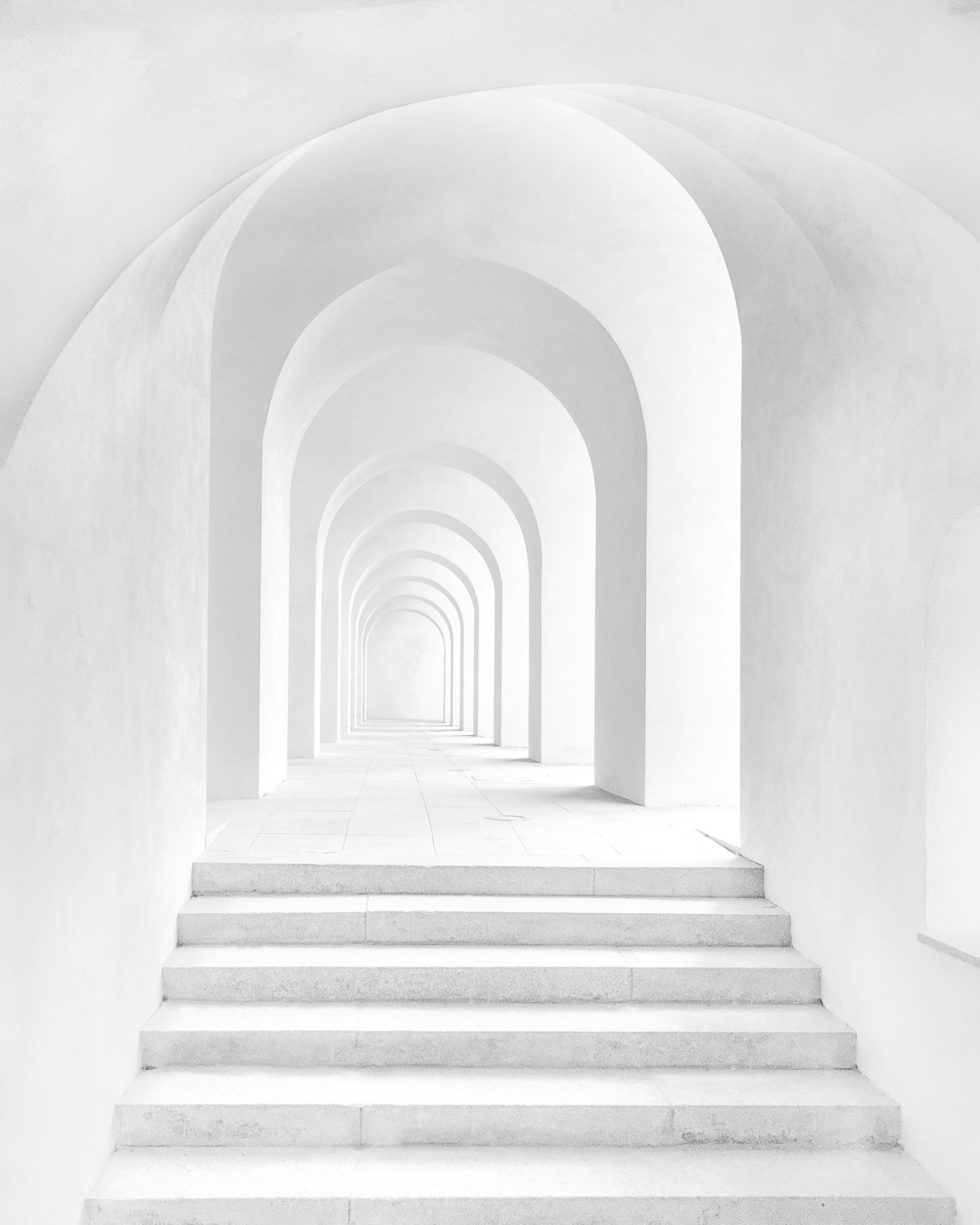 Vaulted stone arcade in soft daylight